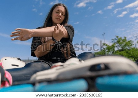 upset girl checks her hands after falling on rollers on roller rink unsuccessful skating injury active recreation hobby