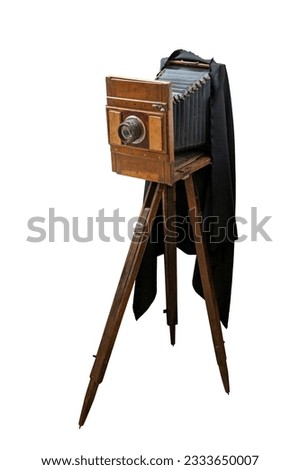 Old vintage wooden large format camera on a tripod isolated on white background with clipping path
