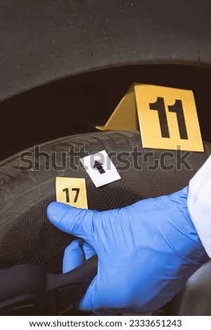 Crime scene investigation - collecting of evidences of soil samples on car wheel Royalty-Free Stock Photo #2333651243