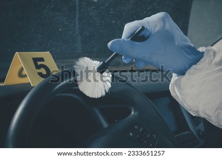 Crime scene investigation - finding and developing of fingerprints in car Royalty-Free Stock Photo #2333651257