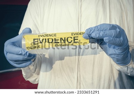 Crime scene investigation - collecting of evidences of soil samples on car wheel Royalty-Free Stock Photo #2333651291