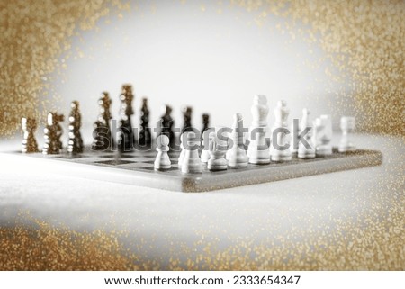 Two chess teams one in front of other on the chessboard. Isolated over white background. High quality photo
