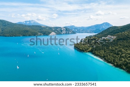 Aerial photography by drone of the Serre-Ponçon lake and its mountains, located in the Hautes-Alpes in France