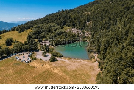 Aerial photography by drone of the Lac de Saint-Apollinaire, near the Serre-Ponçon lake and its mountains, located in the Hautes-Alpes in France