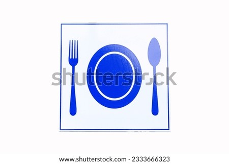 Directional sign fork, spoon, plate blue indicating food outlets area isolated on white background. Signs tell the area to let people know the restaurant, canteen, bistro. in natural light.