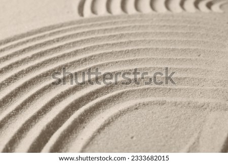 Beautiful lines drawn on sand, closeup. Zen garden