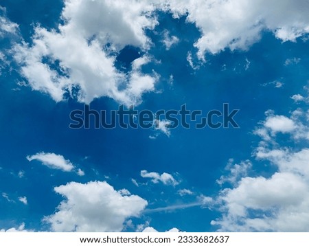 Bright blue sky and white clouds cover a beautiful afternoon sky in Bangkok, Thailand. No focus