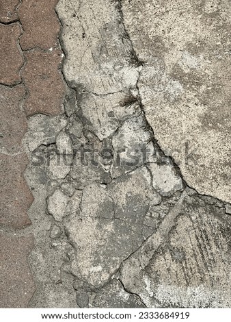 a photography of a close up of a cracked concrete wall, concrete wall with cracks and cracks on it.
