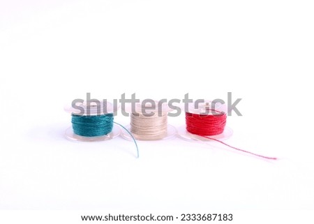 This is a photo shot of sewing thread spool on a white background. 