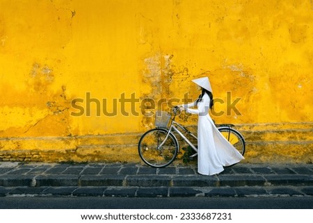 Asian woman wearing vietnam culture traditional at Hoi an, Vietnam. Royalty-Free Stock Photo #2333687231