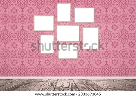 Blank wooden frames hanging on pink patterned wall. Mockup for design