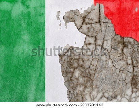 Italian flag on old wall with peeling paint.