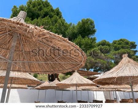Summer vacation background. Tropical holiday banner. Holiday relax in the sun. Island sunshade umbrella against the blue sky.