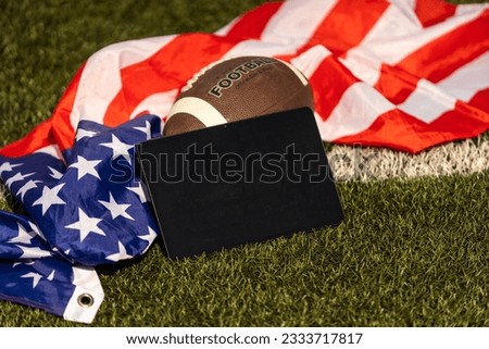 american football ball and tablet, american flag