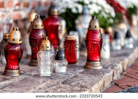 cemetery with flowers and grave candles on a commemoration day Royalty-Free Stock Photo #2333720543