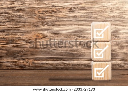 Checklists concept. check mark on wooden cubes