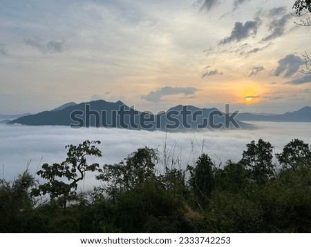 Looking from the top of a mountain, you can see fog covered similar to the sea. Royalty-Free Stock Photo #2333742253
