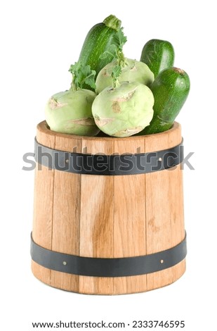 Vegetables in a wooden barrel isolated on white background