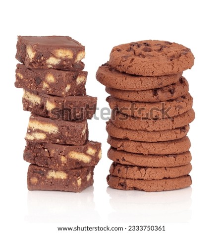 Brownie cakes and chocolate chip cookies in two stacks over white background.