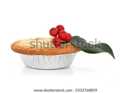 Christmas mince pie with holly berry leaf sprig isolated over white background. isolated over white background.
