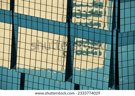 Abstract cose-up of side of urban building reflecting sunlight.