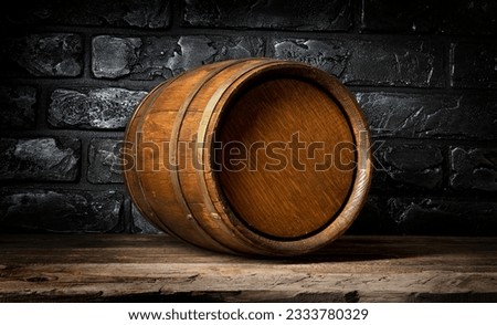 Brick wall and wooden barrel in cellar