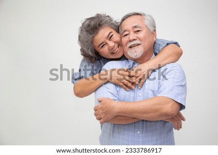 Asian senior couple hugging together isolated over white background, In love anniversary concept Royalty-Free Stock Photo #2333786917