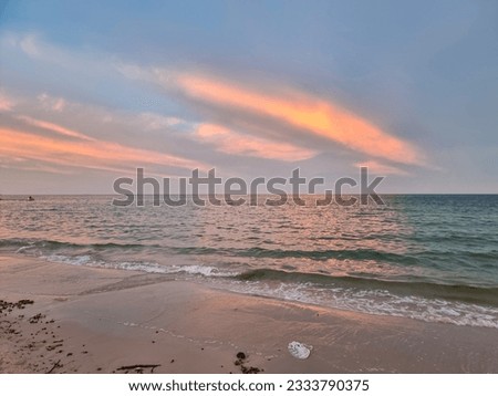 beautiful sand beach sunset on night fresh sea breeze summer vacation. golden and blue sky with white clouds. twilight orange clouds over ocean