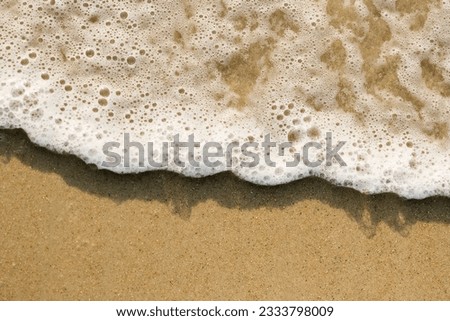 Close-up of sand and wave. Royalty-Free Stock Photo #2333798009