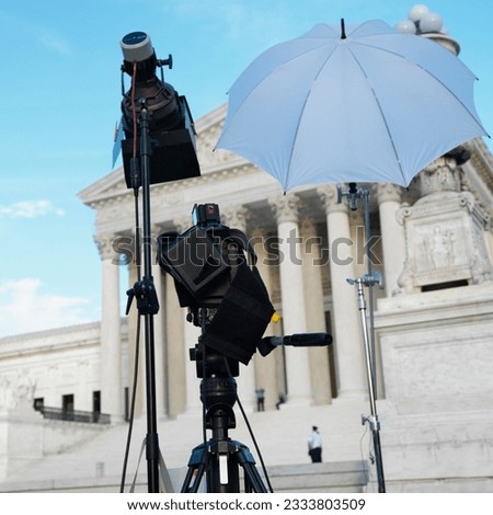 TV production set with camera and lighting equipment on tripods in front of Supreme Court building with in Washington D.C.