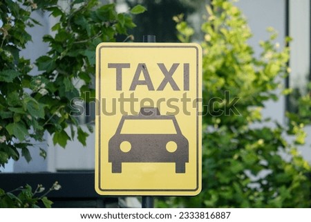 Taxi stand sign at yellow signboard with isolated tree background.