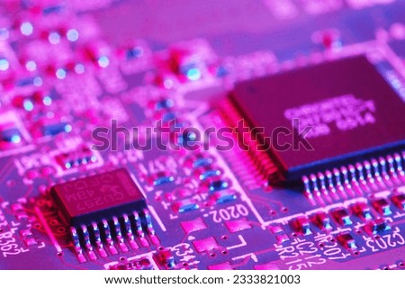 Close-up photo of computer circuit board- blue red tone