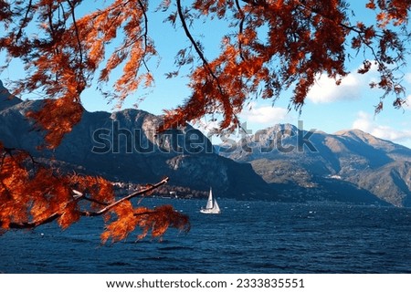 Small sailboat sailing in Como Lake, Italy