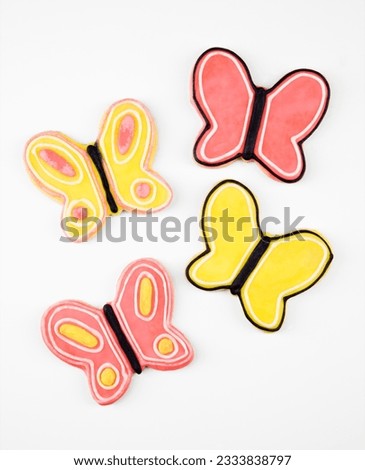 Four butterfly sugar cookies with decorative icing.