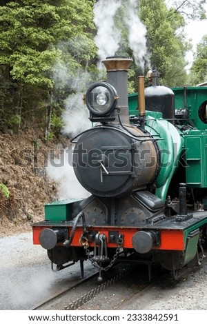 A close shot of a working steam engine showing the rack used to climb steep hills.