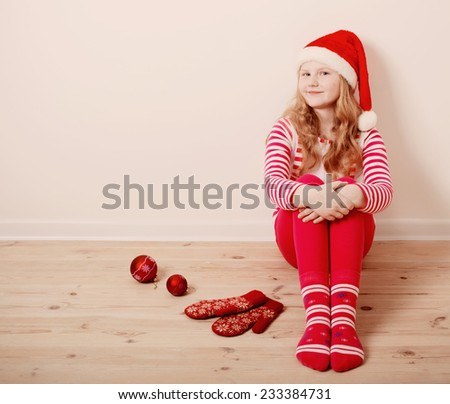 Happy girl dressed in Santa Claus hat