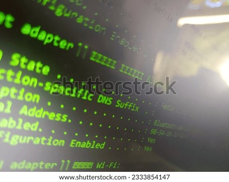 Photo of green text computer monitor displaying information. 