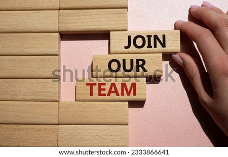 Join our team symbol. Wooden blocks with words Join our team. Beautiful pink background. Businessman hand. Business and Join our team concept. Copy space.
