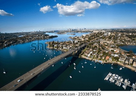 Aerial view of Victoria Road bridge and boats in Sydney, Australia.