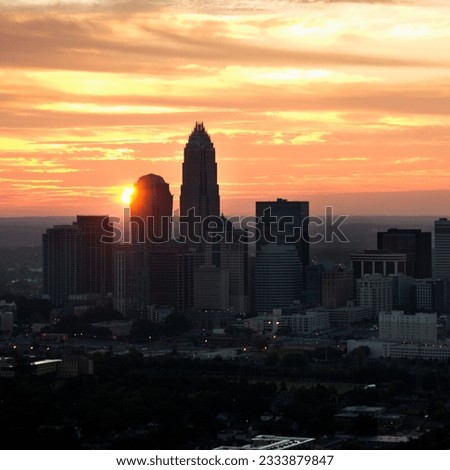 Aerial view of sunset behind city skyline of Charlotte, North Carolina.