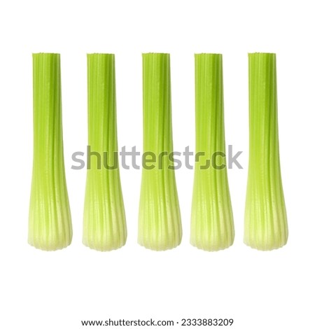 Celery sticks in vertical abstract design over white background.