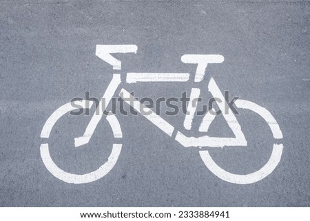 Graphic white image of a bicycle on a bike path.