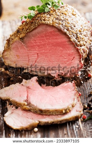 sliced rare beef, roast covered in pepper and herbs