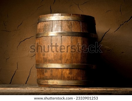 Wooden cask near clay wall in cellar