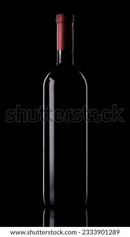 Elegant bottle of red wine on black background