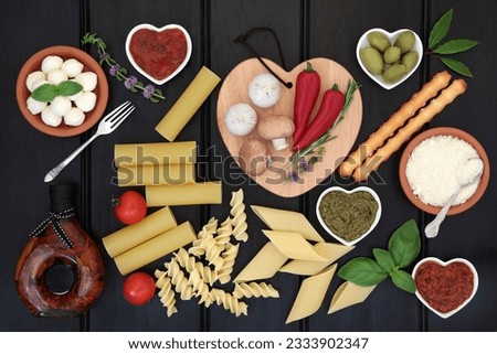 Italian and mediterranean healthy food ingredients over dark wood background.
