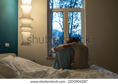 Loving caring man calms down hug embrace upset wife after quarrel. Support in family. Depressed woman need mental help from trouble emotional burnout. Sad couple in trust relations go through crisis Royalty-Free Stock Photo #2333904287