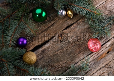  	 Christmas toys on a wooden table with fir tree branches