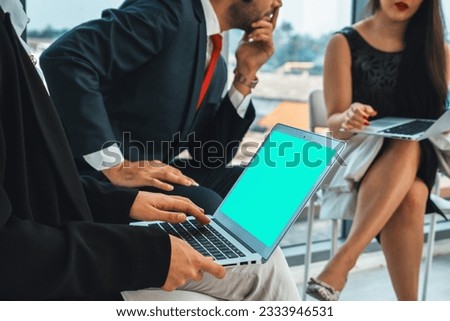 Business people in the conference room with green screen chroma key TV or computer on the office table. Diverse group of businessman and businesswoman in meeting on video conference call . Jivy