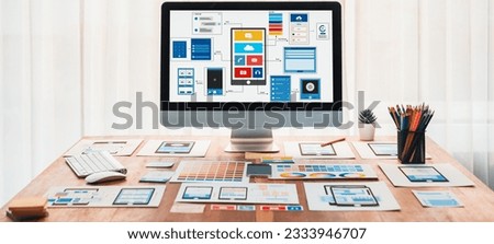 Digital and paper wireframe designs for web or mobile app UI UX display on laptop computer screen. Panoramic shot of developer workspace for brainstorming and design application framework. Scrutinize Royalty-Free Stock Photo #2333946707